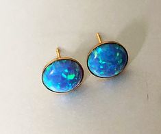 Shop 10mm Blue Opal Earrings Gold, Opal Studs, Opal Jewelry Beautiful blue color will dress up your casual or evening outfit. Opal earrings will make a great present. These earrings are made from: - 10mm blue lab created opal cabochon - Gold plated sterling silver earrings settings - Gold plated sterling silver ear backs You will get silicone ear backs as well. Opal is October birthstone. Earrings will be mailed within 2 business days, nicely packaged and ready to be given. All US orders and mos Blue Opal Earrings, White Opal Earrings, Large Stud Earrings, Evening Outfit, Jewelry Beautiful, Birthstone Earrings, Opal Earrings Stud, Opal Studs, October Birthstone