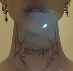 a woman with tattoos and piercings on her neck