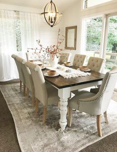 the dining room table is set up with chairs and place settings for people to sit at