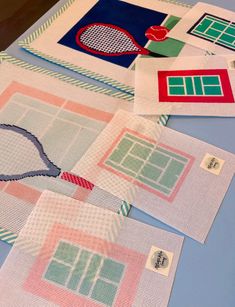 several pieces of paper are laid out on a table with tennis rackets and balls