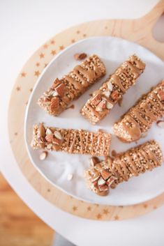 there are some crackers on the plate and one is cut in half with nuts