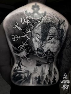 a man's back with a wolf and symbols on his body, in black and white