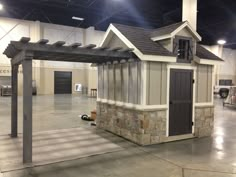 the inside of a building that is made out of concrete and has an open roof