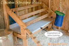 a chicken nesting box with a bench and trash can