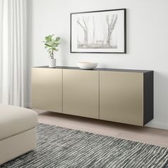 a living room scene with focus on the sideboard and white walls, along with an area rug