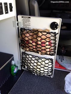 a refrigerator with some food in it on the back of an airplane or plane seat