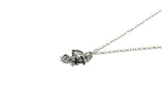 Wear this silver dragon necklace wherever you go to profess your love of the greatest fantasy creature of all time! This understated necklace will add a little dragon elegance to your outfit, whether you're headed to the office or out with friends. Silver-plated dragon charm Silver-plated components Charm: 1 inch long x 5/8 inches wide (2.3 cm long x 1.5 cm wide) Silver Dragon Design Sterling Silver Necklace, Gothic Sterling Silver Necklace With Lobster Clasp, Silver Sterling Necklace With Dragon Design, Gothic Sterling Silver Jewelry With Lobster Clasp, Silver Dragon Necklace, Fantasy Creature, Dragon Necklace, Little Dragon, Silver Dragon