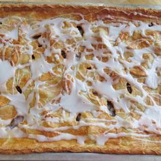 an uncooked pastry with icing on it sitting on top of a pan