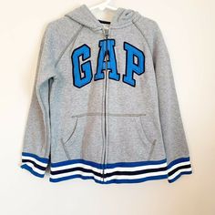 GAP Kids Size Small (6-7) Gray/Blue Logo Full Zip Hoodie Preowned- in excellent condition Please feel free to message me with any questions.  All orders are shipped within one business day.  All items are from a smoke free home. Thank you for checking out my listings! Gap Sweatshirt With Letter Print For Streetwear, Gap Sweatshirt With Double-lined Hood For Streetwear, Gap Hoodie Sweatshirt With Double-lined Hood, Sporty Gap Sweatshirt With Adjustable Hood, Gap Hooded Sweatshirt With Double-lined Hood, Gap Sporty Fleece Sweatshirt, Sporty Hooded Sweatshirt By Gap, Sporty Hooded Gap Sweatshirt, Gap Hoodie With Letter Print For Streetwear