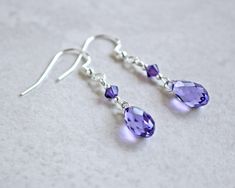 "Tanzanite crystal teardrop earrings are made with tanzanite (blueish purple) Swarovski crystal teardrops accented with purple velvet Swarovski crystals and silver beads.  They dangle 1\"  from sterling silver ear wires. ❖ Crystal Passions crystals ❖ silver fill beads ❖ .925 sterling silver ear wires Earrings shown are on french hook ear wires.  All earring types are sterling silver with the exception of clip-ons, which are silver plated. Hypoallergenic french hooks are stainless steel." Crystal Earring Ideas, Swarovski Earrings Diy, Diy Earrings Dangle, Briolette Earrings, Tanzanite Crystal, Blueish Purple, Diy Jewelry Earrings, Crystal Teardrop Earrings, Beaded Earrings Diy