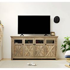 a flat screen tv sitting on top of a wooden cabinet