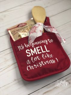 a small red bag filled with candy and some kind of cookie on top of a wooden table