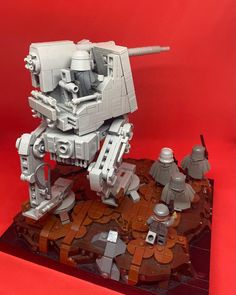 a lego star wars at - at is set up on top of a red background