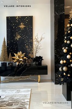 A modern and elegant interior space featuring a Christmas tree decorated with gold and black ornaments, next to a sleek black console table with gold star-shaped objects and miniature trees. A large vertical artwork with gold accents on a black background hangs behind the table. The room is well-lit with natural light reflecting off glossy floor tiles. Black And Gold Christmas Decorations, Black Gold And White Christmas Tree, Gold And Black Christmas Decor, Gold And Black Decor, Black And Gold Christmas Decor, Glossy Floor, Vertical Artwork, Black Ornaments, Black And Gold Christmas