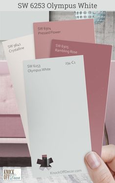 a person holding up some pink and white paint swatches with the words sw 663 olympic white on them