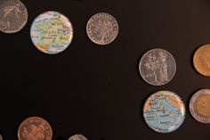 several different types of coins are arranged on a black surface, including one for the united states