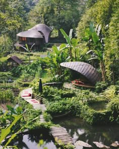 an outdoor area with water, trees and boats in the foreground is surrounded by greenery