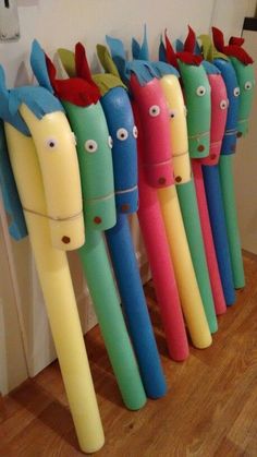 several colorful toothbrushes are lined up in a row on the floor next to a door