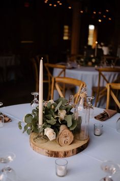 the table is set with wine bottles and candles