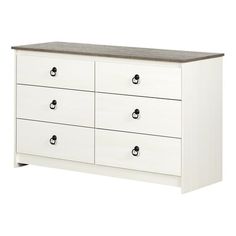 a white dresser with black handles and drawers