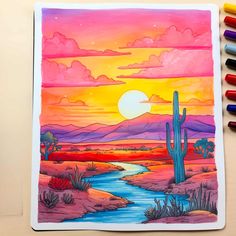 a drawing of a desert scene with a river and cactus in the foreground, surrounded by colored crayons