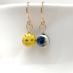 "This Tiny Sun and Moon Earring pair will cheer you up day and night:) Dimensions The earring charms are about 1/4\" (6.4mm) - 5/16\" (8mm) in diameter. Materials Porcelain Clay Underglaze Colors Mid-Fire Clear Glaze Gold overglaze Gold filled wire Care Instructions While porcelain clay is durable, it is not shatter-proof. Please wear and handle with care! The necklace may be washed with soap and water if needed. No scrubbing. PLEASE NOTE Because this is a handmade item, the item you receive wil Clay Underglaze, Alt Accessories, Sun And Moon Earrings, Moon Earring, Sun And Moon Necklace, Celestial Gifts, Tiny Cats, Cat Mom Gifts, Earring Charms