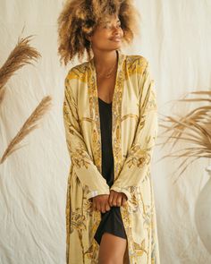 Our Short Kimono offers an easy, relaxed fit, combining comfort with understated elegance. Its fluid silhouette adds a touch of effortless charm to any outfit, making it a versatile piece for both casual days and special moments. Flowy Long Sleeve Kimono For Loungewear, Spring Long Robe With Relaxed Fit, Spring Loungewear Tops With Kimono Sleeves, Chic Summer Outerwear For Loungewear, Fitted Kimono For Spring Loungewear, Bohemian Relaxed Fit Kimono For Daywear, Flowy Long Sleeve Kimono For Day Out, Relaxed Fit V-neck Kimono For Loungewear, Casual Oversized Kimono For Daywear