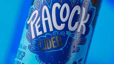 a close up of a bottle of beer on a blue background with the word peach cider