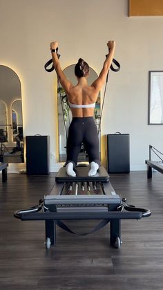 a woman is doing exercises on a treadmill