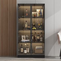 an empty chair sits in front of a tall glass cabinet with liquor bottles on it