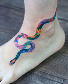 a woman's foot with a colorful tattoo on it