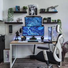 a computer desk with two monitors on top of it and shelves above the desk behind it