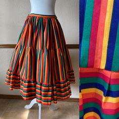 Gorgeous full circle rainbow skirt from the 70s! Pictured with a petticoat, not included -The only tag has a handwritten 30 on it -This feels like a cotton poly blend -Would fit a size small, 23" to 27" waist (maybe a tight 28") -Length: 29.5" Each side of the waist ties, so the waist is adjustable.  The ties can either be tied at the sides, or can be wrapped around each way and tied in the front and in the back.  There is no elastic and no other closures besides the ties.  The skirt is unlined. Very good vintage condition!  Clean and ready to wear. The only thing to note is light marking on part of the ties, but it's very faint and won't be seen when worn and ties are tied. This skirt is a wonderful piece and the colors are incredibly vibrant! All vintage items are unique and pre-loved, a Retro Full Skirt Petticoat With Ruffles, Vintage Long Skirt Petticoat, Retro Fitted Skirt For Festival, Vintage Skirted Petticoat With Lined Skirt, Vintage Cotton Flared Skirt Bottoms, Vintage Cotton Flared Skirt, Retro Skirted Cotton Bottoms, Vintage Tiered Skirt Bottoms For Festival, Vintage Multicolor Skirt For Spring