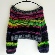 a multicolored sweater hanging on a hanger