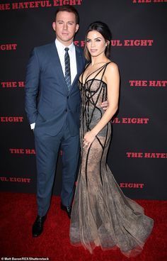 a man and woman posing on the red carpet at the hateful eight film premiere