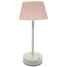 a white table lamp with a pink shade