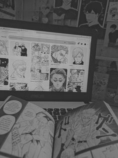 an open book sitting in front of a laptop computer with comics on the screen and behind it are pictures of people's faces