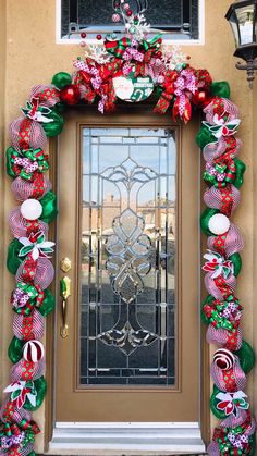 the front door is decorated for christmas with candy canes and bows on it's sides