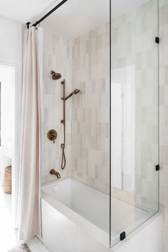 a bathroom with a tub, shower head and hand held faucet in it