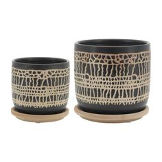 two black and white cups sitting next to each other