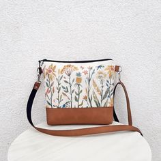 "FLOWER GARDEN" - Natural white cotton crossbody bag. - Medium or Small bag  - Water repellent canvas - Suitable have any clothes - Strong and pleasant to carry bag - Natural material from nature - Medium  bag, but with good internal volume - Hand made colorful print on the front - Hardware color silver Made of Thick natural White cotton.  Combined with vegan leather - Camel color. Two outer pockets on the front side - for size Medium only. Universal bag for your everyday life, for sport, for th Floral Print Shoulder Bag For Everyday Use, Floral Print Crossbody Shoulder Bag For Everyday Use, Everyday Floral Print Crossbody Shoulder Bag, Spring Hobo Pouch Bag For Everyday Use, Bohemian Canvas Bag For Everyday Spring Use, Spring Floral Print Shoulder Bag For Everyday Use, Beige Floral Print Shoulder Bag For Everyday Use, Spring Canvas Crossbody Shoulder Bag, Everyday Canvas Shoulder Bag With Floral Print