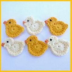 four crocheted ducks sitting next to each other on a white surface with yellow border