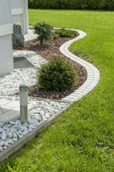 a garden with rocks and grass around it