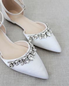 "Embellished pointy toe flats with sparkly row of teardrop rhinestones across toe and detachable ankle strap. Comfort with simplicity perfect for brides and bridesmaids. YOU CAN CHOOSE STYLE OF ANKLE STRAP AT CHECKOUT Details: Colors available: Black, Blush, Burgundy, Champagne, Light Blue, Navy, Red, Royal Blue, Ivory, and White UPPER: Synthetic upper and lining MATERIALS: Mandmade outsole STYLE NAME: BELLA SIZE FIT: RUNS LARGE, ORDER HALF SIZE DOWN FROM YOUR NORMAL SIZE Not sure of which size Flat Wedding Shoes With Rhinestones, Wedding Flats With Rhinestones And Flat Heel, Wedding Flats With Rhinestones, Embellished Pointed Toe Flats, Embellished Flat Heel Wedding Shoes, Embellished Pointed Toe Wedding Shoes, Silver Closed Toe Flats For Wedding, Fall Wedding Shoes, Ivory Bride