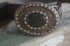 "This one of a kind beaded belt buckle measures 3 5/8\" x 2.5\" and fits 1 1/2\" snap belts. A variety of semi-precious and glass beads adorn this buckle. Sealed and water resistant with a high gloss resin. This buckle will add a touch of glamour and boho chic to any outfit. Custom designs available. Belt straps are sold separately." Handmade Adjustable Belt Buckles As Gift, Handmade Artisan Belts For Gifts, Handmade Artisan Belt As Gift, Elegant Handmade Adjustable Belt, Handmade Bohemian Belt Buckles As Gift, Elegant Handmade Belt Buckles As Gifts, Beaded Belt, Green Agate, Wedding Places