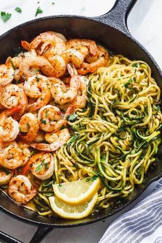 pasta with shrimp, lemon and spinach in a skillet