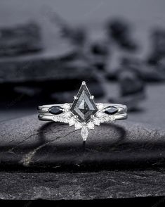 a black and white photo of an engagement ring