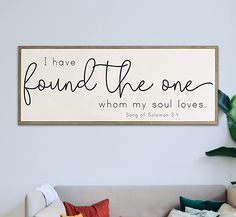 a living room filled with furniture and a sign on the wall that says i have found the one whom my soul loves