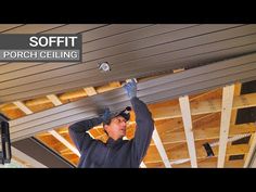 a man is working on the ceiling in his garage