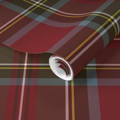 a red and green plaid wallpaper with a white circle in the center on it